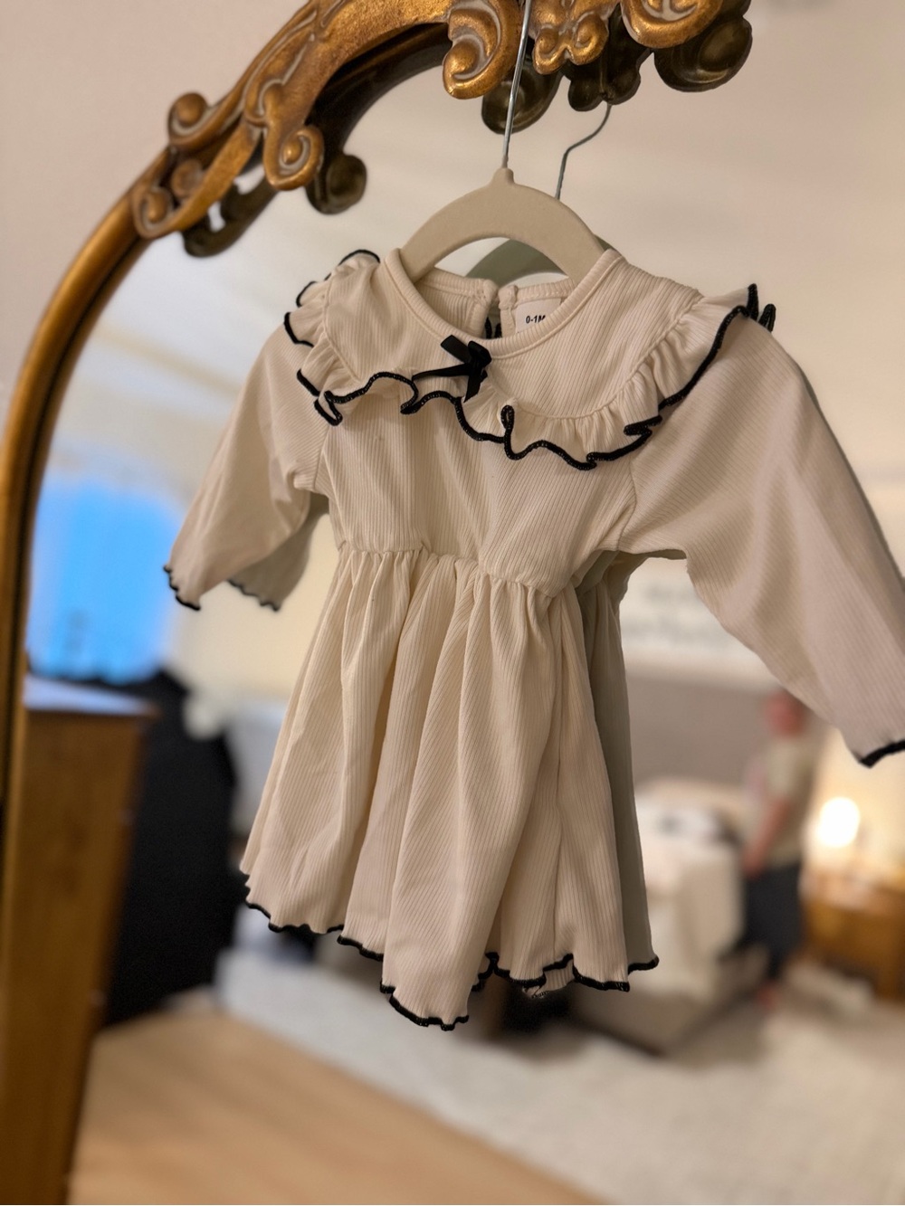 Cream Ruffle Baby Dress with Black Trim
